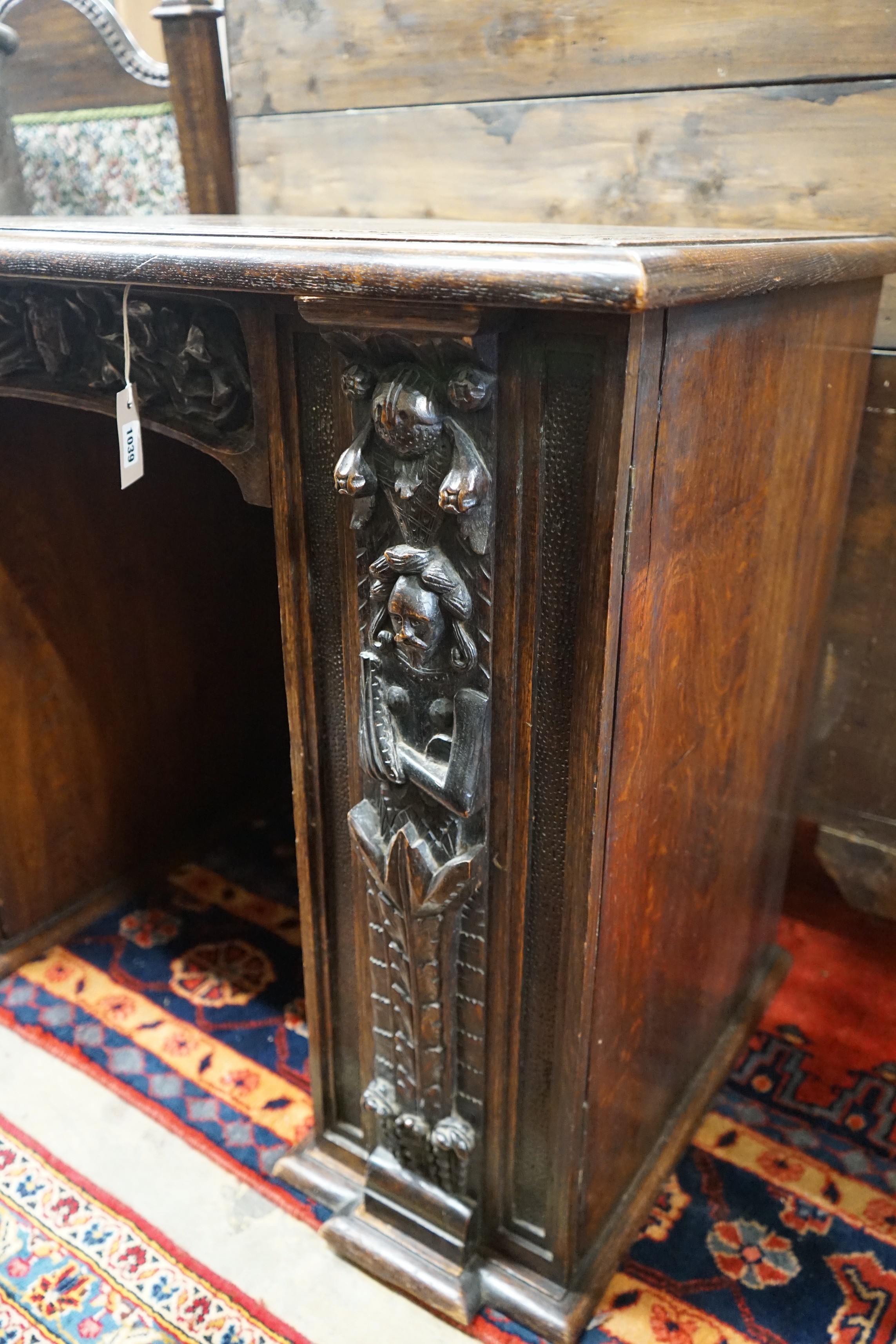 An 18th century carved oak kneehole desk, width 105cm, depth 59cm, height 81cm